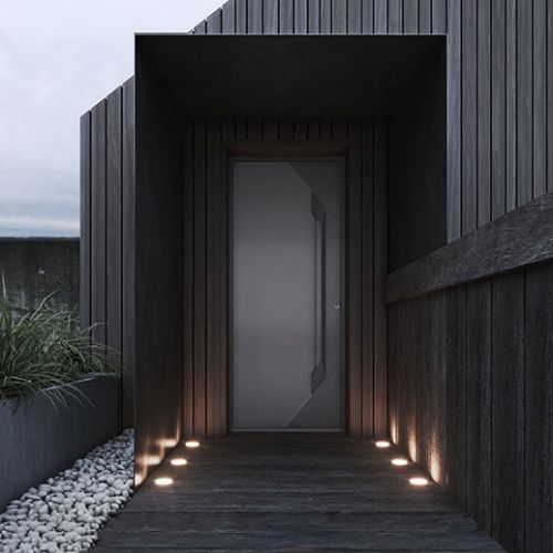 porte d'entrée pleine en aluminium vue extérieure, avec un design moderne de nuit